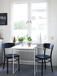 Kitchen design with a table by the window photo