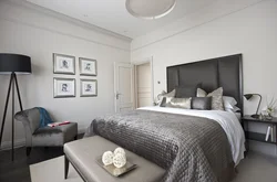 Bedroom interior with gray wallpaper and brown furniture