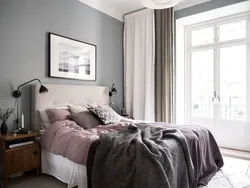 Bedroom interior with gray wallpaper and brown furniture