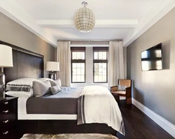 Bedroom interior with gray wallpaper and brown furniture