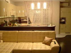 Photo of a living room kitchen with a sofa at the table