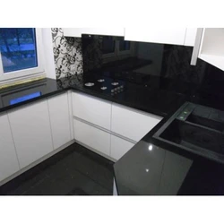Black glossy countertop in the kitchen photo