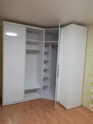 Small corner wardrobe in the bedroom for clothes photo