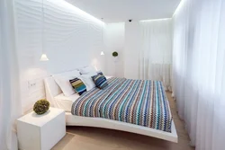 Bedroom design with a bed along the wall photo