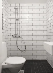 White bathtub with black grout photo