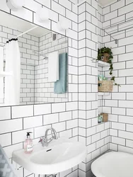 White bathtub with black grout photo