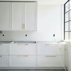 Handles on white kitchen facades photo