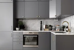 Kitchen with a gray countertop and apron in the interior photo