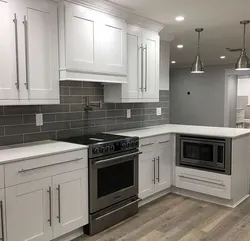 Kitchen with a gray countertop and apron in the interior photo