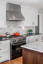 Kitchen with a gray countertop and apron in the interior photo