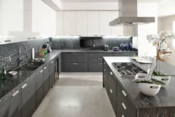 Kitchen with a gray countertop and apron in the interior photo