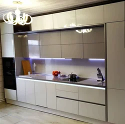 Design of a straight kitchen in a modern style with a refrigerator