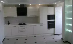 Straight kitchen design with refrigerator on the right