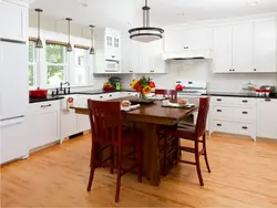 White kitchen interior with brown table