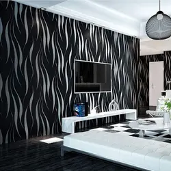 If the living room has black and white wallpaper photo
