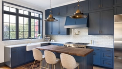 Blue kitchen in the interior photo with wooden