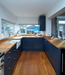 Blue kitchen in the interior photo with wooden