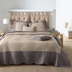 Bed with a blanket in the bedroom interior