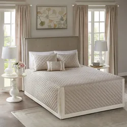Bed with a blanket in the bedroom interior