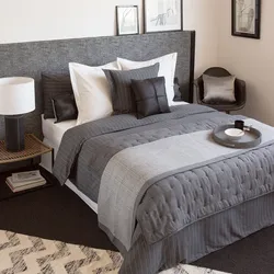 Bed with a blanket in the bedroom interior