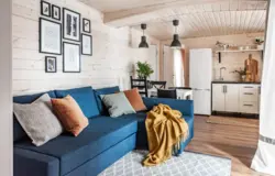 Living room kitchen design in a house with clapboard