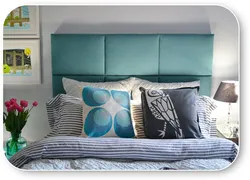 Turquoise bed in a bedroom interior with a soft headboard