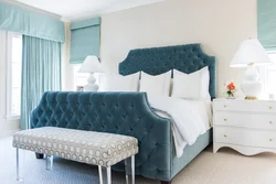 Turquoise bed in a bedroom interior with a soft headboard