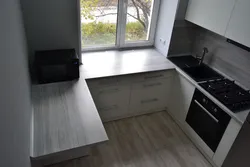 Window sill as a countertop in the kitchen photo in Khrushchev