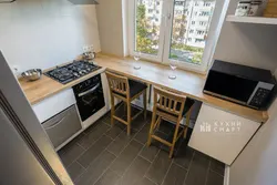 Window sill as a countertop in the kitchen photo in Khrushchev