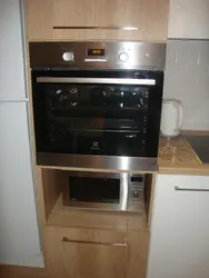 Photo of a kitchen with built-in oven and microwave