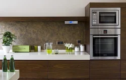 Photo of a kitchen with built-in oven and microwave