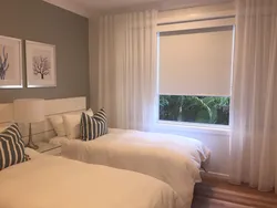 Roller blinds in the bedroom in the interior photo