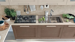 Sink and stove next to each other in the kitchen photo