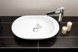 Bathroom sink overlay on the countertop photo of the bathtub