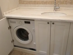 Bathroom countertop for washing machine and sink photo