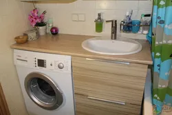 Bathroom countertop for washing machine and sink photo