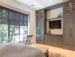 Full-wall bedroom wardrobe design with TV