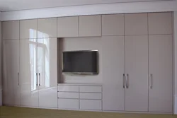 Modern wardrobes with TV in the bedroom photo