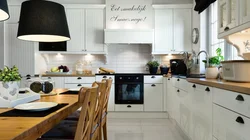 White kitchen with wooden countertop and black handles in the interior