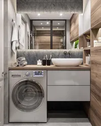 Bathroom design with a sink above the washing machine photo