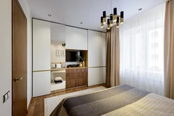 Wardrobe with TV in bedroom interior
