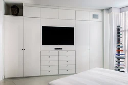 Wardrobe With TV In Bedroom Interior