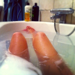 Photo of feet in a bathtub covered in foam