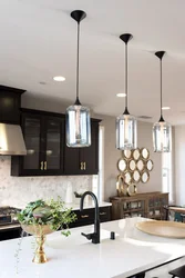 Pendant lamps above the bar counter in the kitchen in the interior