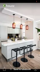 Pendant lamps above the bar counter in the kitchen in the interior