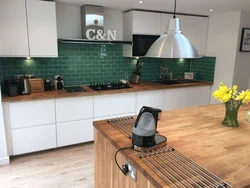 Kitchen with green tile splashback design