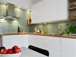 Kitchen with green tile splashback design