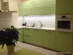 Kitchen with green tile splashback design