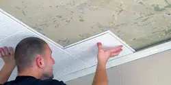 Ceiling tiles in the bathtub on the walls photo