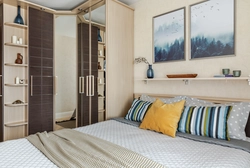 Small bedroom design with corner wardrobe